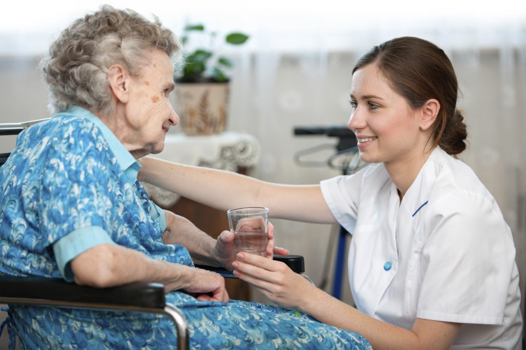 Senior woman with her caregiver at home